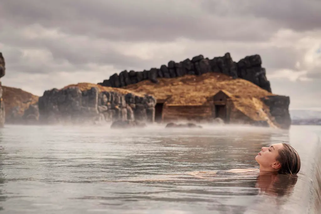 Famous spa in Iceland woman floating in Sky Lagoon